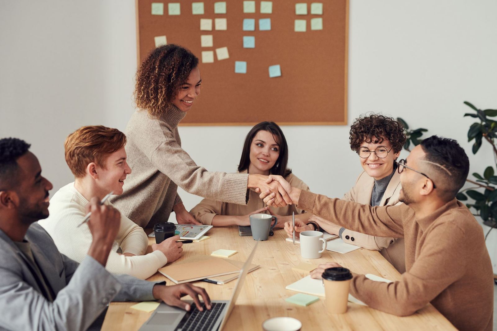 A diverse team gathered around a table for an onboarding discussion