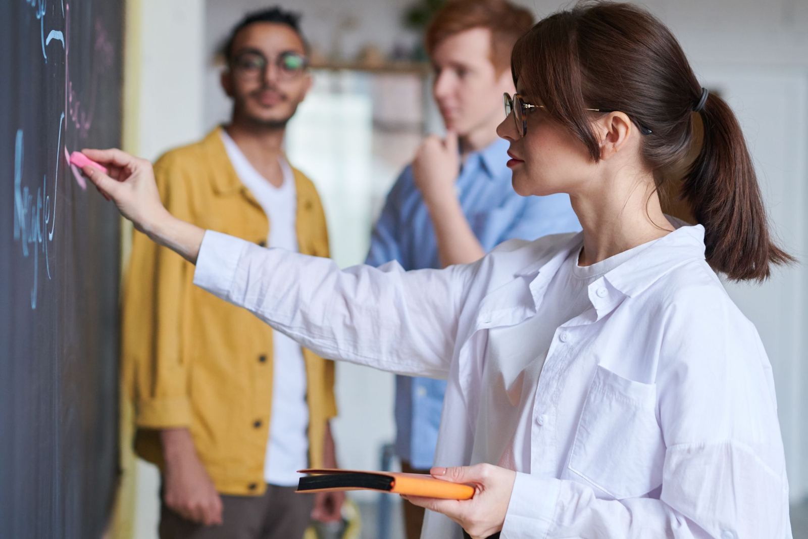 A team presenting and reviewing a workflow at a wall